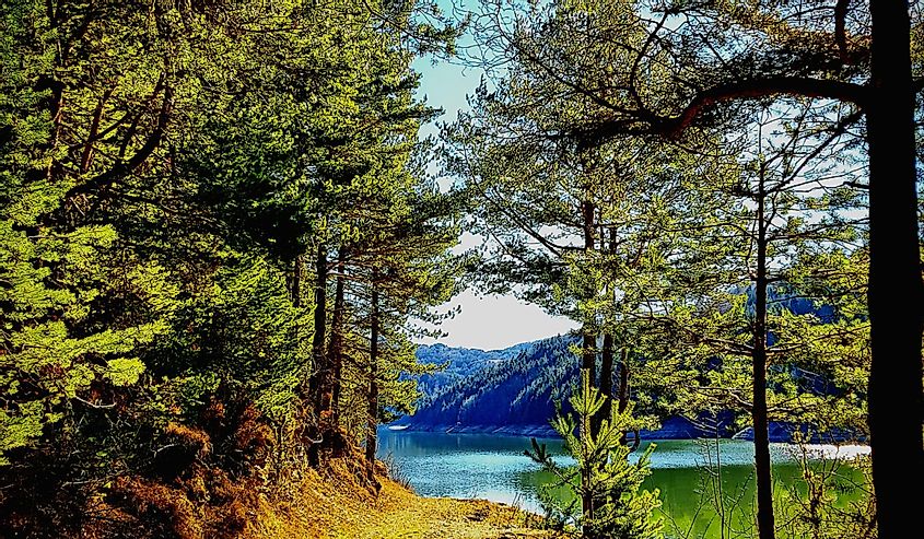 Berovo Lake Path, Macedonia featuring mountains and river.