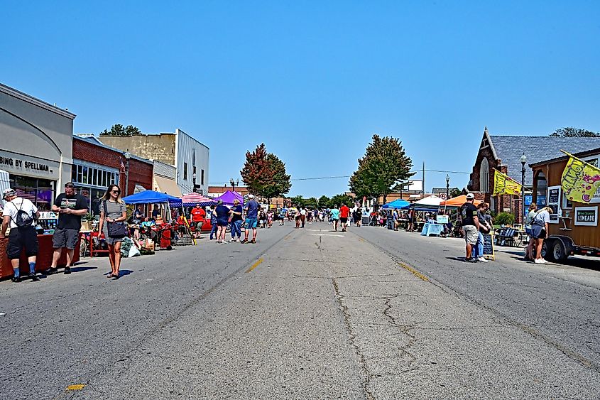 People browsing booths along Commercial Street in downtown Emporia, Kansas.