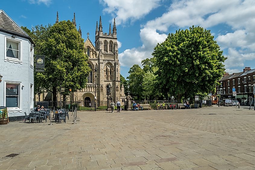 Market Place with the George Inn and Selby Abbey in summer sunshine.