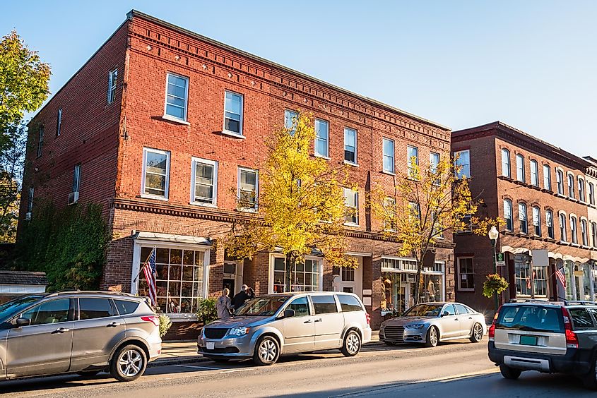 Traditional American brick buildings with shops along a busy street at sunset