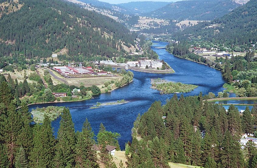 Clearwater River flowing near Orofino, Idaho, with tree-covered hills in the background.