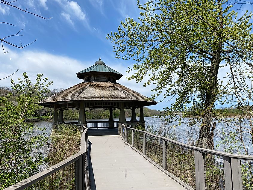 A sizeable gazebo marks the end of a riverside boardwalk.