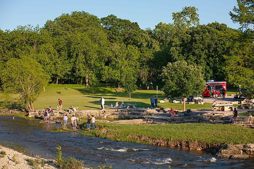 People enjoying the water in Salado, Texas, via https://visitsaladotexas.com/