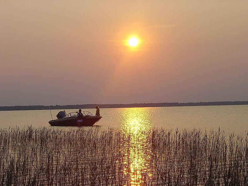 Boat on the water at sunset at Lake Waccamaw