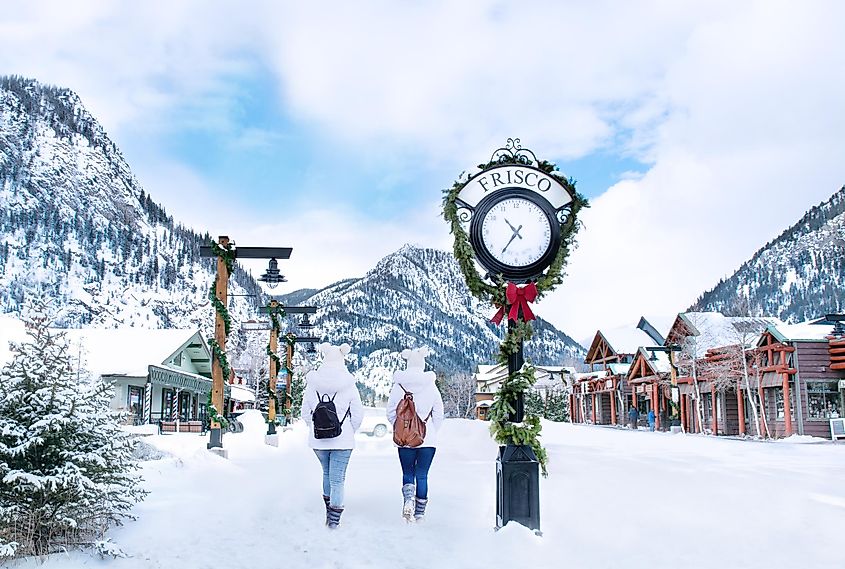 Friends hiking the snowcapped mountains and houses in Frisco, Colorado