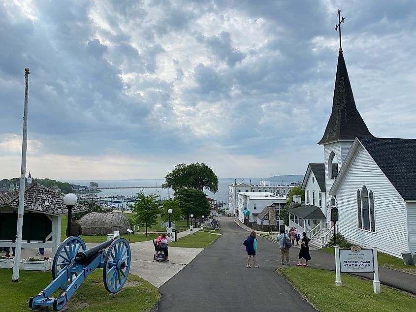 A canon and old church look down upon more of Mackinac Island village and its Lake Huron waterfront.