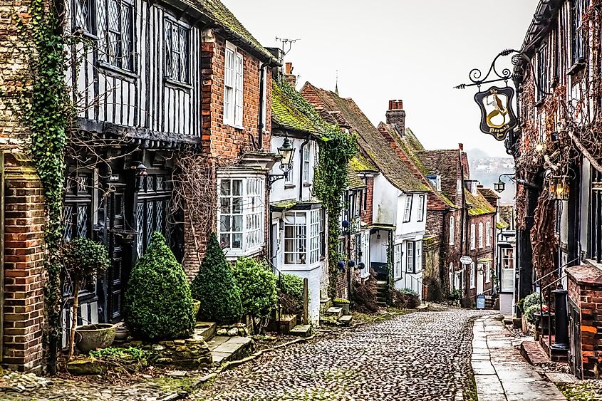 Cobblestone street lined with rustic buildings in Rye, England.