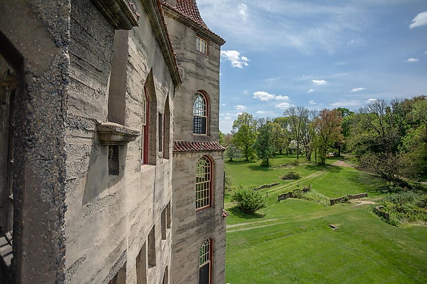 Partial view of Fonthill Castle in Doylestown, Pennsylvania, a renowned tourist destination, under a sunny sky.