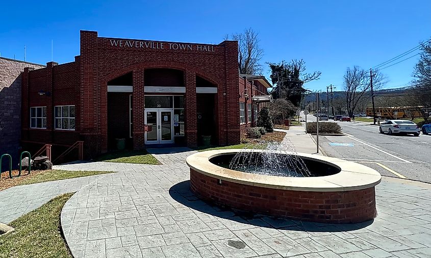 Weaverville Town Hall, a stout, modern building made of red brick overlooking a fountain