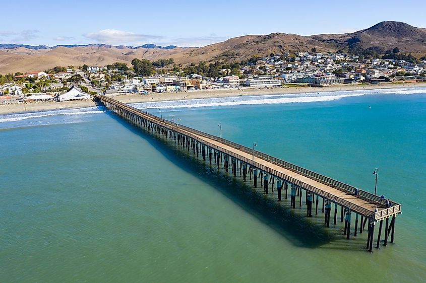 A long pier reaches out into the Pacific Coast in the quaint city of Cayucos, California.