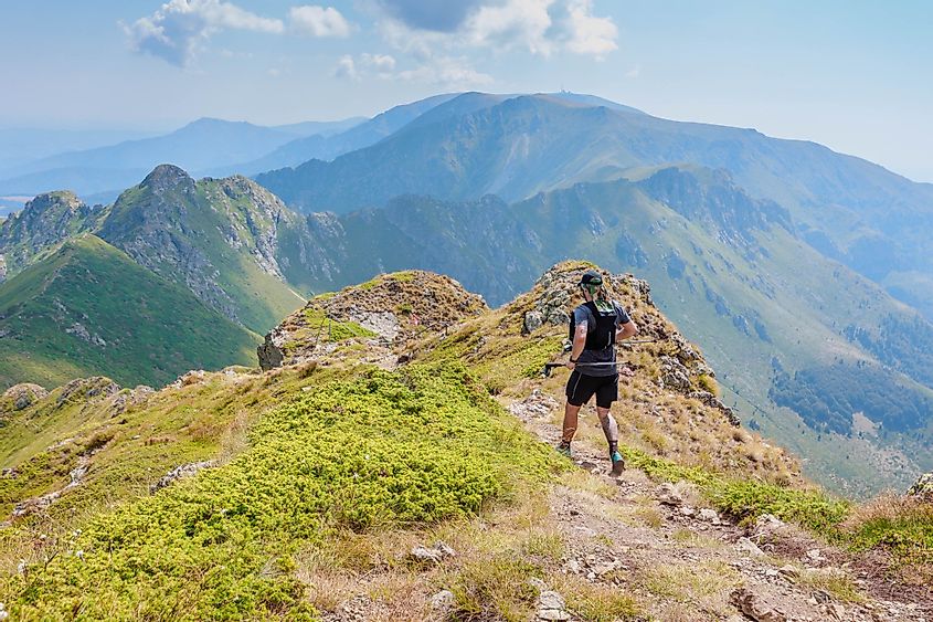 A lone runner racing along the ridgeline of the Balkan mountains.