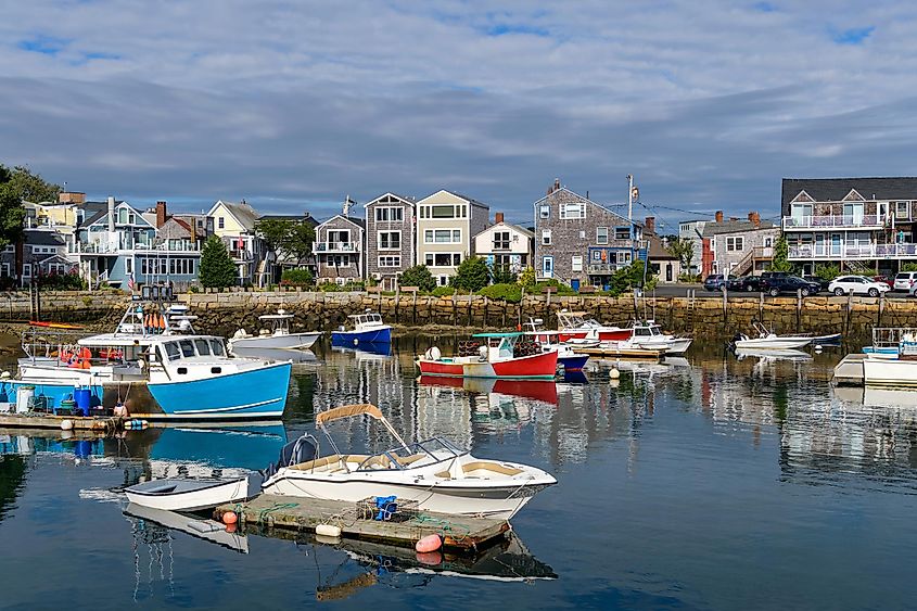 A sunny Autumn morning view of colorful fishing boats docking in the peaceful inner harbor of Rockport, a small seaside resort town at tip of Cape Ann, near Boston, Massachusetts