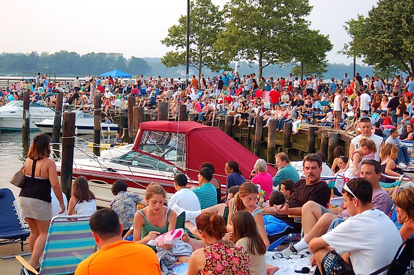 A large crowd gathers in a park in Red Bank New Jersey to watch a firework show near the Fourth of July