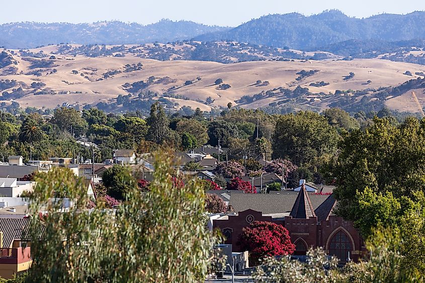 Afternoon sun shines on a historic church and city landscape of downtown Hollister, California.