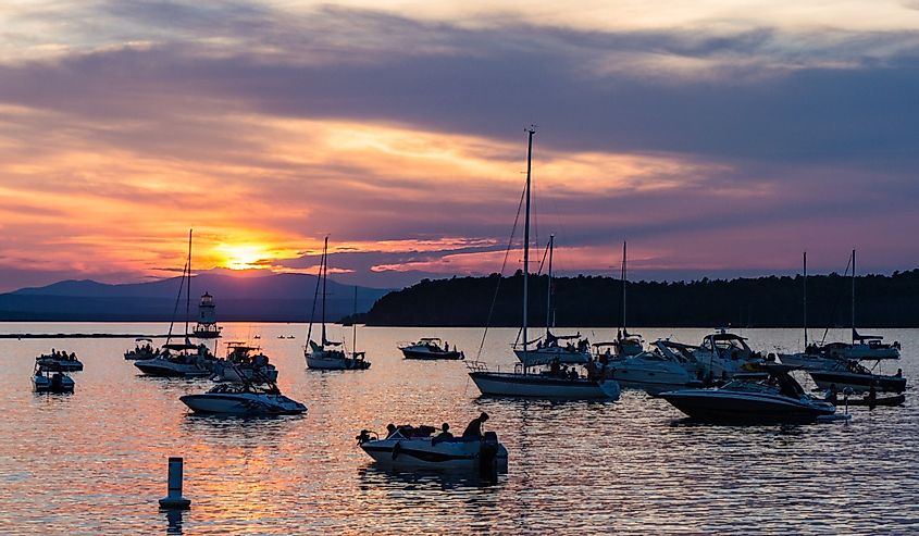 Boaters watching the sunset on Lake Champlain on a summer evening