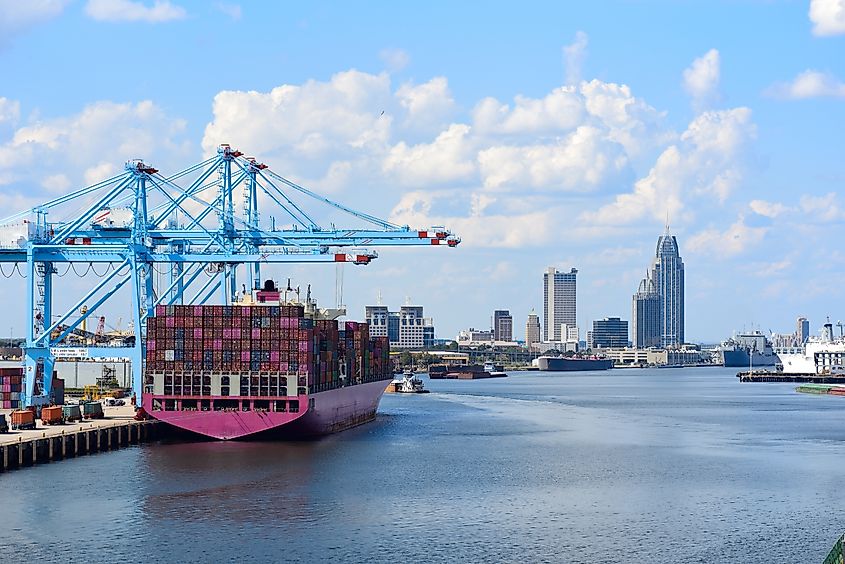 Downtown of Mobile, Alabama, USA and city docks as seeing from port harbor. Via Shutterstock / nektofadeev