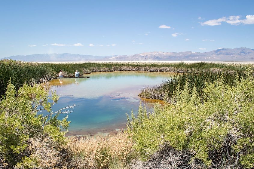 A couple sits on the dock at the Black Rock Hot Springs in Gerlach, Nevada