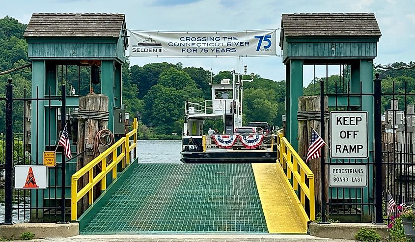 Green gate for Chester-Hadlyme Ferry with boat heading off to the other shore. Second oldest ferry in continuous use in Connecticut.