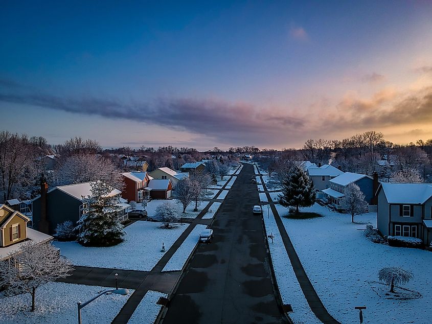 Newly fallen snow blankets the streets of a subdivision in Beavercreek, Ohio, as the morning sun rises.