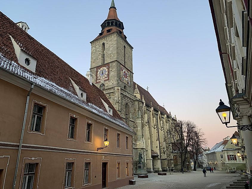 The large Gothic Cathedral known as the "Black Church." It is late afternoon in the wintertime. Lanterns are just lighting up.  