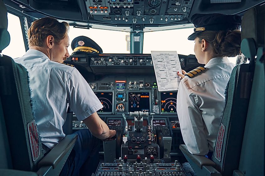 A pilot and a female first officer seated in the flight deck.