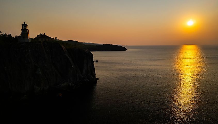 An aerial view of Split Rock Lighthouse at a scenic golden sunrise.