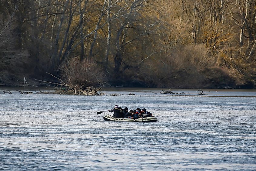 Migrants on a dinghy cross the Evros river to reach Greece as they are pictured from the Turkish border city of Edirne, Turke