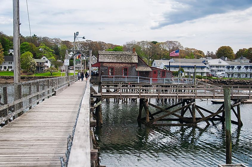 The historic Boothbay Harbor footbridge connecting both sides of the village of Boothbay Harbor, Maine, USA, on a spring day at low tide.