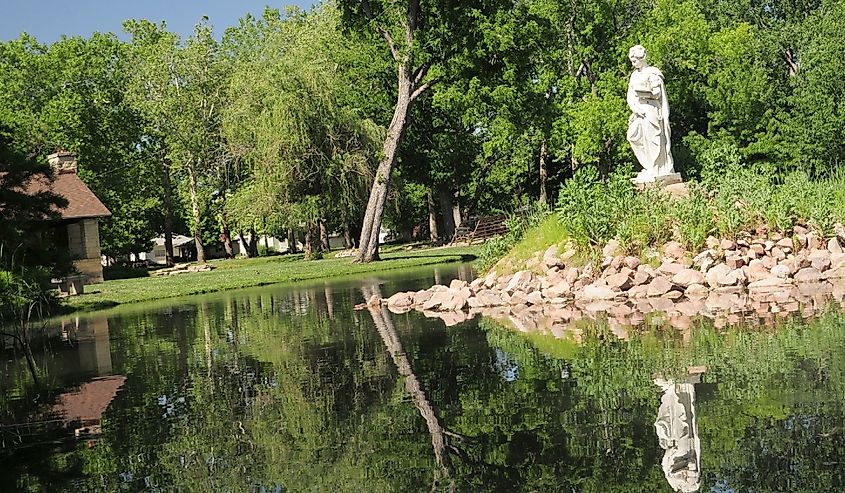 Reflections-Old statue in pond Wamego, Kansas