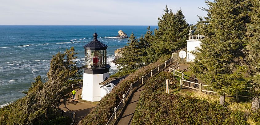 Pacific Ocean waves crash against high bluffs below Cape Mears Lighthouse