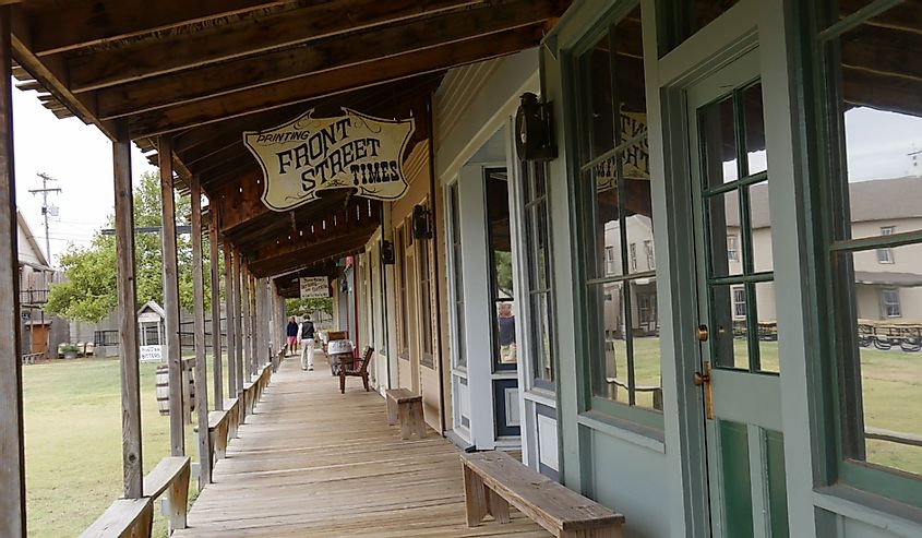 View outside the Front Street replica with a sign board of the Front Street Times printing shop at the Boot Hill historical museum in Dodge City, Kansas.