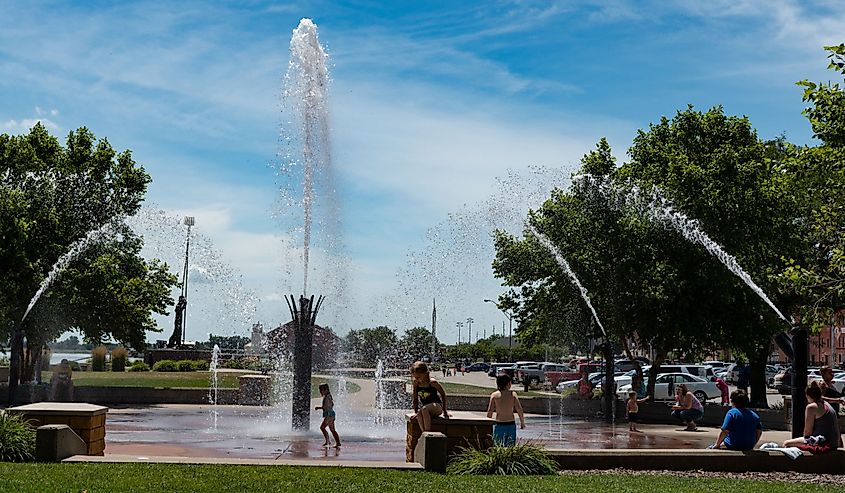Children beating the heat by playing in the fountains at Riverfront Park in Muscatine.