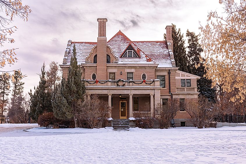Sheridan, Wyoming United States of America- December 10, 2022: Historic Kendrick Mansion decorated for Christmas. Beautiful winter scene with snow on the ground.