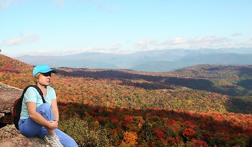 Hiker enjoying autumn view from Giant Ledge, Catskills, New York