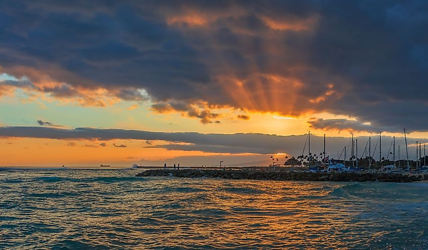 Stunning sunset with sunbeams shining through storm clouds in Waipahu, Oahu, Hawaii