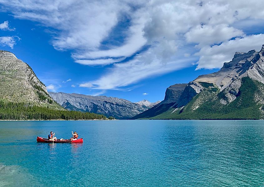 Canoeing on a summer day in the crystal clear waters of Lake Minnewanka, Banff National Park, Alberta, Canada. 
