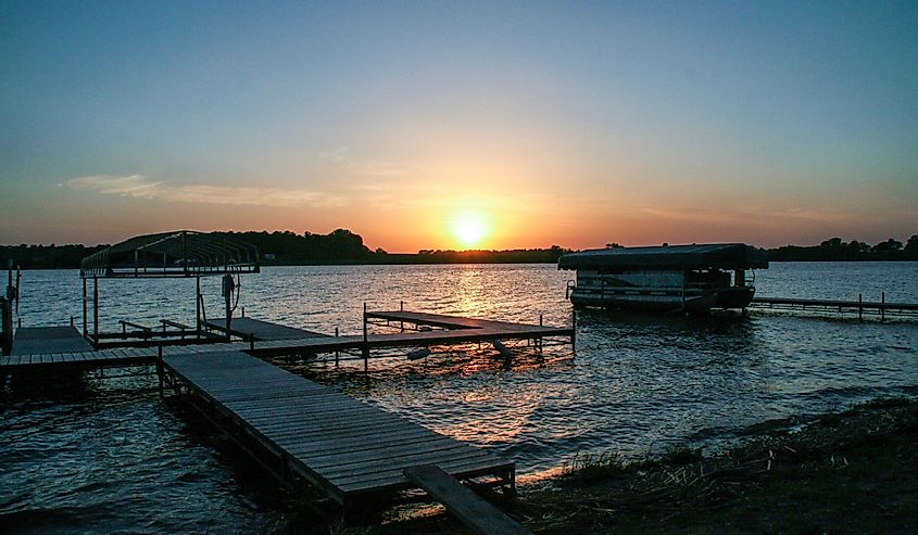Sunset on a dock with pontoon boat on Lake Reno in Alexandria, Minnesota