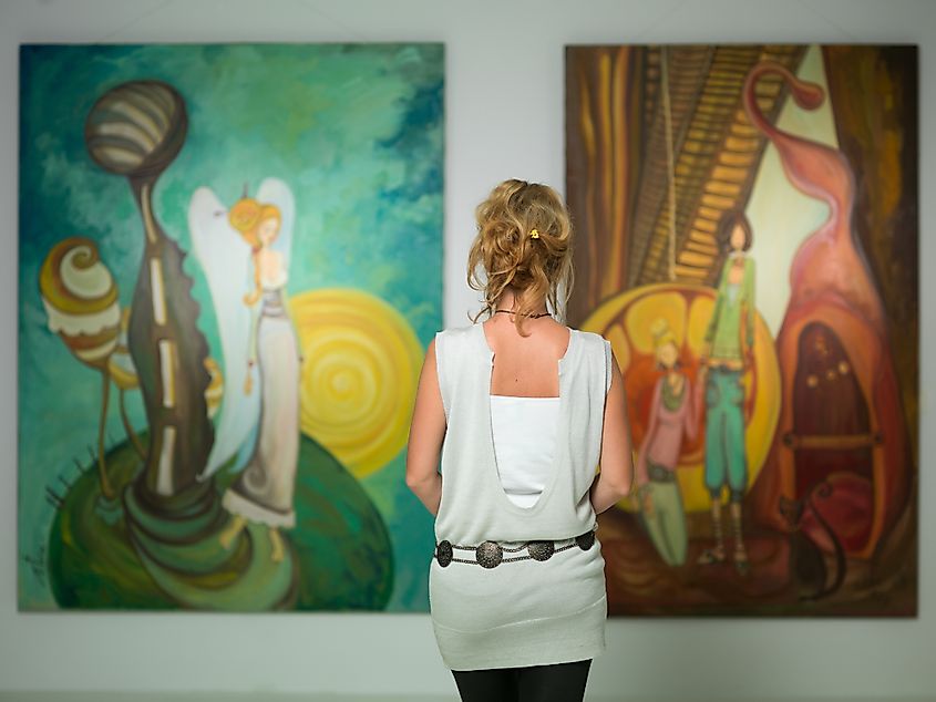 A lady admiring paintings. Such experiences are studied by Aesthetics.