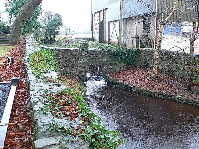 Croaghrum River running between St Cronan's Church and O'Grady's castle in Tuamgraney, Ireland. 