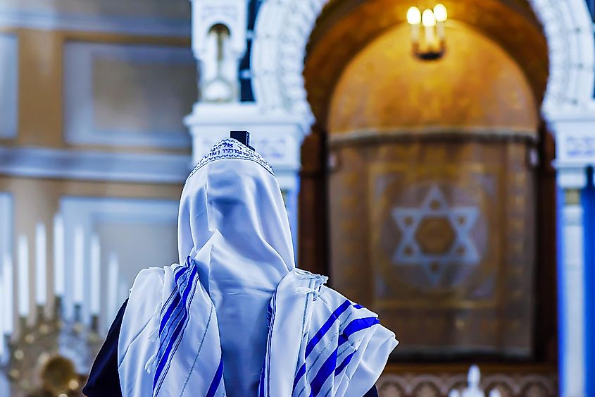 A Jewish person praying at a Synagogue