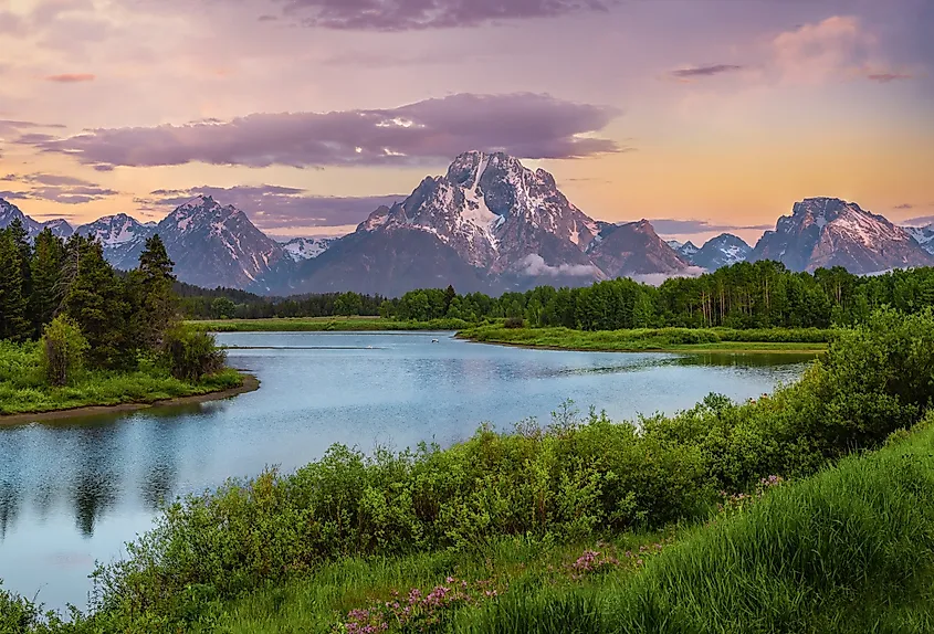 Snow-capped Teton Range rising above a valley in Grand Teton National Park.