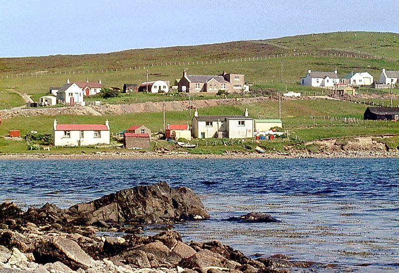 Brae across the waters of Busta Voe, Shetland, ScotlandHousing in Brae across the waters of Busta Voe by Alan Reid, CC BY-SA 2.0 <https://creativecommons.org/licenses/by-sa/2.0>, via Wikimedia Commons. Credit: 