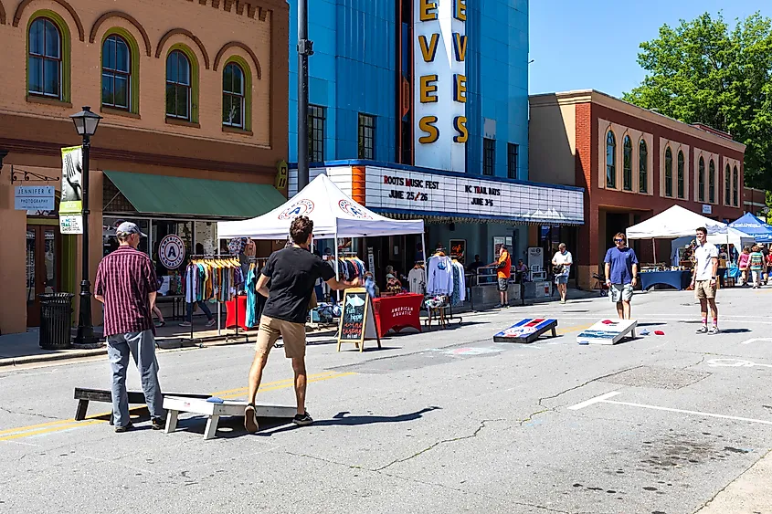 Four young men playing cornhole or corn toss in Elkin, North Carolina. 