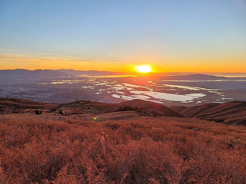 Bright photo of a sunset over the wetlands of Farmington Utah.