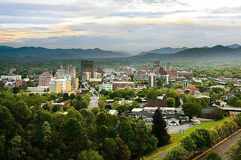 The skyline of downtown Asheville, North Carolina at sunset with the Blue Ridge mountains in the background
