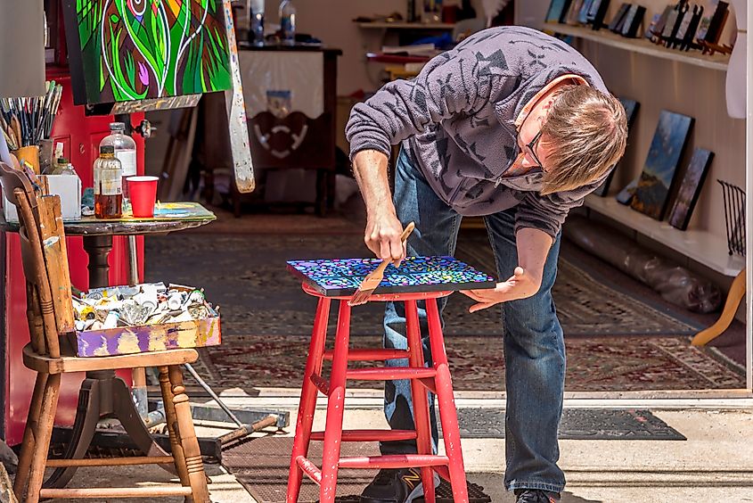 An artist stands in his studio in Rockport.