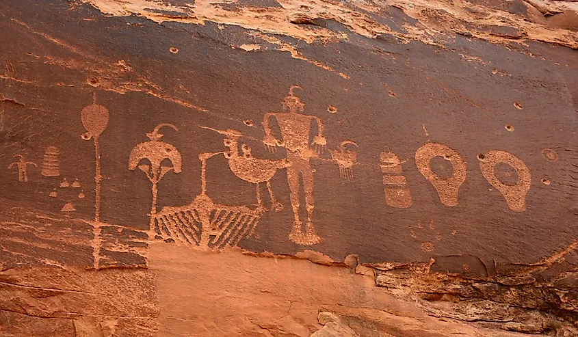 ancient native american wolfman petroglyph panel in comb ridge, near bluff, utah