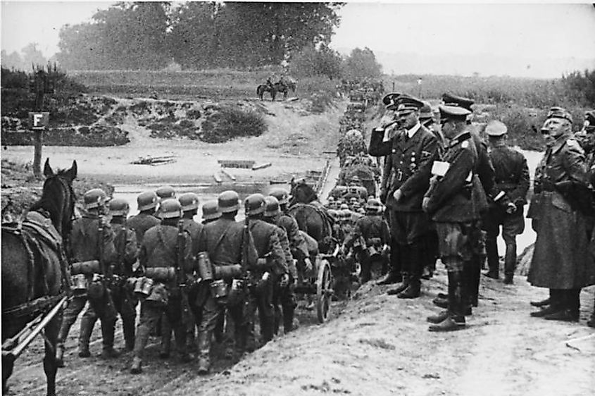 Hitler watching German soldiers march into Poland in September 1939.