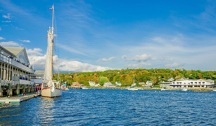 Sail boat on Boothbay Harbor at sunset in autumn, Maine