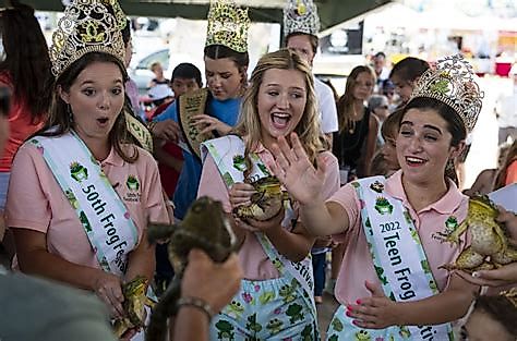 Participants in the Rayne Frog Festival posing with frogs.